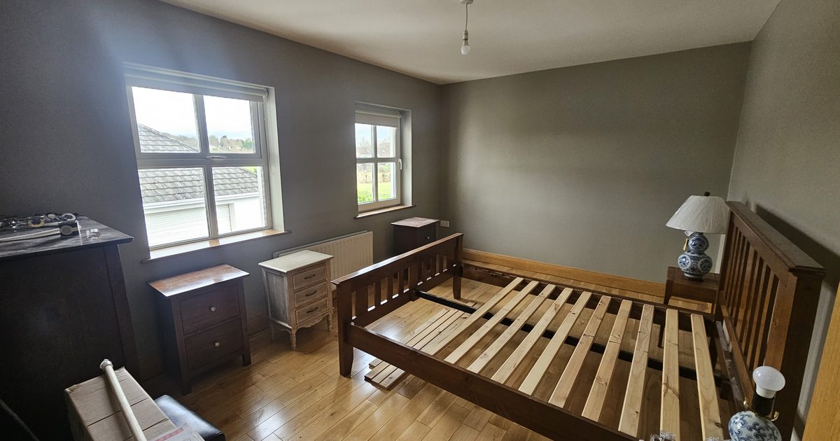 Painter working around furniture in a living room in Carrickmacross Co Monaghan