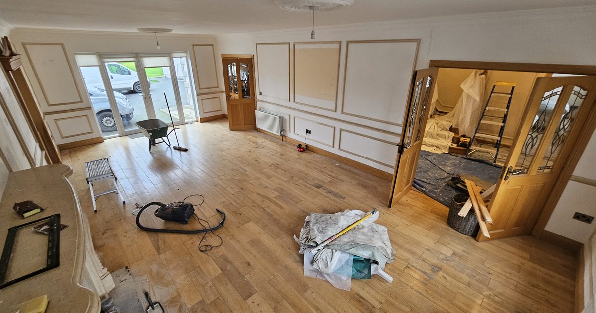Decorator painting a room in the correct order in a house in Co Monaghan Ireland